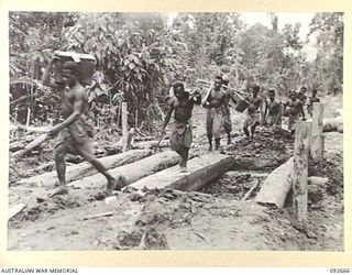 MINGA CREEK, WEWAK AREA, NEW GUINEA. 1945-05-30. A NATIVE PACK TRAIN CARRYING SUPPLIES TO FORWARD INFANTRY UNITS IN THE PRINCE ALEXANDER MOUNTAINS. THIS WAS THE MAIN MEANS OF SUPPLY AS THE USE OF ..