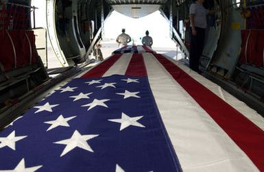 During a commemorative ceremony at Hickam Air Force Base (AFB) Hangar 35, inside a US Air Force (USAF) C-17A Globemaster III, members of a joint honor guard prepare to carry the remains believed to be of unaccounted-for Americans, recovered in Vietnam and Papua New Guinea. The remains will be taken to the Joint POW/MIA Accounting Command's Central Identification Laboratory (JPAC CIL) where they will attempt to positively identify the remains so they can be returned to their families