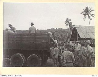 MUSCHU ISLAND, NEW GUINEA. 1945-09-11. JAPANESE SOLDIERS UNLOADING THE FIRST OF RATIONS SUPPLIED BY HEADQUARTERS 6 DIVISION TO JAPANESE PERSONNEL ON MUSCHU AND KAIRIRU ISLANDS. THE RATIONS ..