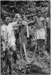 Snake, which has been partially skinned, is held up for display