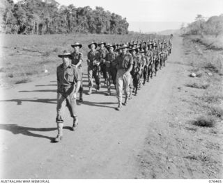 LAE, NEW GUINEA. 1944-10-07. A MARCH PAST OF THE 2/8TH COMMANDO SQUADRON. IDENTIFIED PERSONNEL ARE:- NX13338 LIEUTENANT C.A.R. STARKEY (1); QX24485 LIEUTENANT D.W. ASTILL (2); CORPORAL T.A.G. ..