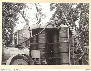 BOUGAINVILLE, SOLOMON ISLANDS. 1944-12-10. MEMBERS OF D TROOP, 5 BATTERY, 2 FIELD REGIMENT, ASSISTED BY CORPORAL K. HIGGINS, 5 FIELD COMPANY, FILL A WATER CART FROM A WATER POINT CONSTRUCTED BY THE ..