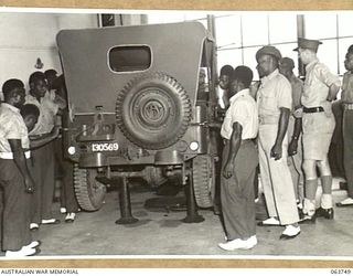 1944-01-26. AUSTRALIAN AND NEW GUINEA ADMINISTRATION UNIT NATIVES WATCHING THE FINAL ENGINE CHECK AND INSPECTION OF A JEEP AT THE FACTORY OF THE FORD MOTOR COMPANY