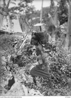 YAULA, NEW GUINEA. 1944-04-09. A NATIVE CARRIER BRINGING SUPPLIES ALONG THE BOGADJIM ROAD FROM SCOTT'S CREEK TO B COMPANY, 57/60TH INFANTRY BATTALION