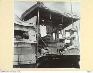 HANSA BAY, NEW GUINEA. 1944-07-10. MEMBERS OF THE 5TH DIVISION SALVAGE GROUP EXAMINE AN ABANDONED JAPANESE AIRCRAFT MACHINERY LORRY EQUIPPED WITH LATHE, VALVE FACER, DRILL, GUILLOTINE, HYDRAULIC ..