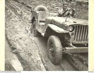 WAMPIT, NEW GUINEA. 1944-03-01. THE ROAD 65 1/2 MILES FROM WAU. AT THIS POINT THE WAU - LAE SECTION IS NOTHING MORE THAN MUD TRACKS. IT IS AN OPERATIONAL AREA OF THE HEADQUARTERS, COMMANDER ROYAL ..