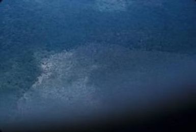 [Aerial view of forested hills on Espiritu Santo, Vanuatu]