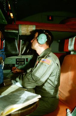 CPT Mel Soterlund, navigator, 374th Tactical Airlift Wing, makes calculations as he guides his C-130 Hercules aircraft toward a Micronesian island during a Christmas Drop mission. The annual airdrop is a humanitarian effort providing aid to needy islanders throughout Micronesia during the holiday season