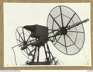 PORT MORESBY, NEW GUINEA. 1943-12-16. ANGLE SHOT OF THE (SEARCHLIGHT CONTROL) SITE TESTING EQUIPMENT AT THE HEAVY ANTI-AIRCRAFT GUN SITE H.8, ROYAL AUSTRALIAN ARTILLERY. SHOWING LEFT TO RIGHT: ..