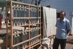 During the Swan Song Expedition (1961) a member of the crew took this photo of a Nansen bottle racks and a Russian technician aboard the Russian R/V Vitiaz (ship) in Honolulu harbor, Hawaii. September 1961