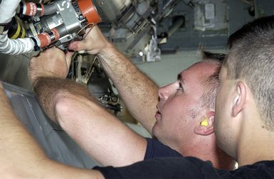 US Air Force (USAF) STAFF Sergeant (SSGT) John Beldin (left) and USAF SSGT Landon Favors both Weapons Loaders assigned to the 2nd Bomb Wing (BW), installs a Conventional Air Launch Cruise Missile into the weapons bay of a USAF B-52H Stratofortress aircraft while deployed with the 7th Air Expeditionary Wing (AEW) at Andersen Air Force Base (AFB), Guam, during Operation ENDURING FREEDOM