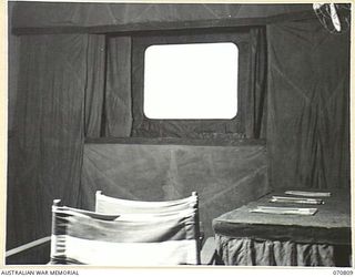 PORT MORESBY, NEW GUINEA, 1944-03-08. THE INTERIOR OF THE "G" (VISUAL TRAINING) THEATRETTE, HEADQUARTERS, NEW GUINEA FORCE. THE THEATRETTE, WHICH HOLDS 12 PEOPLE COMFORTABLY, IS VIEWED FROM THE ..