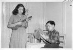Mae Enseki and her brother Richard, Jr., relax at their hobbies in their new home in New York City. They