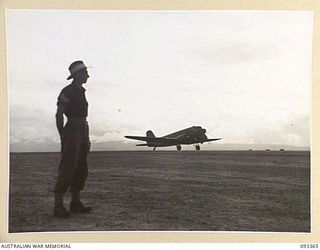 JACQUINOT BAY, NEW BRITAIN, 1945-06-24. AN RAAF DOUGLAS C47 DAKOTA MAIL PLANE TAKING OFF FROM JACQUINOT AIRSTRIP