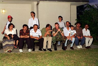 CAPT. John Keane, SENIOR Arabic Linguistic, Combat Service Support Detachment 37 holds a conversation with Kurdish evacuees during their festivities of Eid-af-altar. This is a Muslim tradition that celebrates the end of Ramadan, a month of fasting and gaining spiritual enlightenment