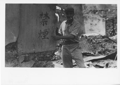 Chas A.Sims in front of "No Smoking" sign