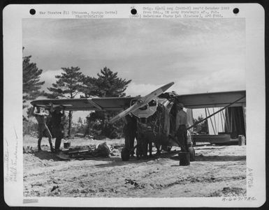 Men Attach A Wing To One Of The Vultee L-5 Of The 163Rd Liaison Squadron Attached To The 10Th Army. The Plane Has Just Been Uncrated At Cub Field No. 7 On Okinawa, Ryukyu Retto, After Shipment From Hawaii. 1945. (U.S. Air Force Number A64717AC)