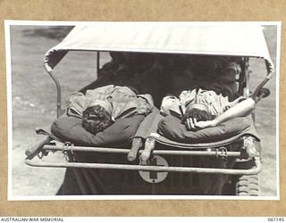 12 MILE, PORT MORESBY AREA, NEW GUINEA. 1943-12-03. DEMONSTRATION OF A JEEP AMBULANCE DESIGNED AND BUILT BY THE TROOPS OF THE 2ND AUSTRALIAN MOTOR AMBULANCE CONVOY