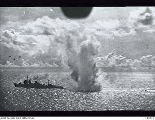 Finschhafen area, New Guinea. 1943-03-03. Shipping under attack from Allied aircraft. The tail wheel of the attacking aircraft is seen at the top of the photograph