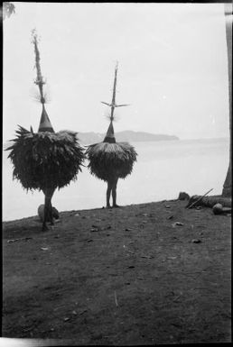 Two Dukduks standing on a beach, Rabaul Harbour, New Guinea, 1929, 2 / Sarah Chinnery