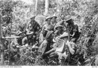 WAREO, NEW GUINEA. 1943-12-09. VX7410 LIEUTENANT (LT) D. C. LAWRIE OF CAMBERWELL, VIC, DCM OF C COMPANY, WHO WON HIS DECORATION AT LAE AND WAS TWICE MENTIONED IN DESPATCHES, AUTOGRAPHS A JAPANESE ..