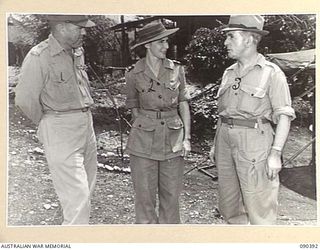 JACQUINOT BAY, NEW BRITAIN. 1945-04-08. SENATOR J.M. FRASER, ACTING MINISTER FOR THE ARMY (3), AND MAJOR GENERAL A.H. RAMSEY, GENERAL OFFICER COMMANDING 5 DIVISION (1), SPEAKING WITH SISTER H.K. ..