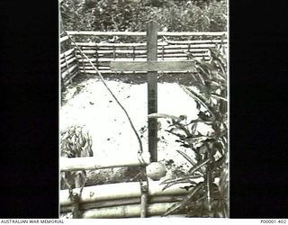 NEW IRELAND, 1945-10. JAPANESE MARKED BAMBOO ENCLOSURE, PROBABLY THE BURIAL SITE OF THE CREW OF A CRASHED AIRCRAFT AS DESCRIBED IN PHOTOGRAPH P0001/418/401. (RNZAF OFFICIAL PHOTOGRAPH.)