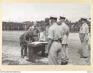 CAPE WOM, NEW GUINEA, 1945-09-13. LIEUTENANT-GENERAL ADACHI, COMMANDER 18 JAPANESE ARMY IN NEW GUINEA, SIGNING THE INSTRUMENT OF SURRENDER. HE ACCEPTED THE TERMS UNCONDITIONALLY. LIEUTENANT-GENERAL ..