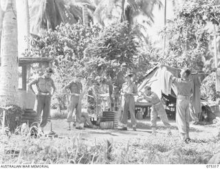 NAGADA, NEW GUINEA. 1944-08-16. PERSONNEL OF E TROOP, 22ND BATTERY, 106TH TANK ATTACK REGIMENT ENJOYING A QUIET GAME OF QUOITS IN THEIR CAMP AREA. IDENTIFIED PERSONNEL ARE:- V505385 GUNNER L.A. ..