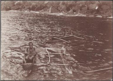 Boys in canoes off the coast of Merelava, Banks Islands, 1906 / J.W. Beattie