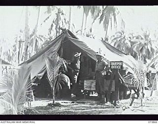 MADANG, NEW GUINEA. 1944-06-15. VX106354 SERGEANT L. R. MORRISON (LEFT) AND VX1406020 DRIVER N. H. SCHULLER, OUTSIDE THE TRANSPORT OFFICE, HEADQUARTERS, 15TH INFANTRY BRIGADE. THE UNIT IS AT ..