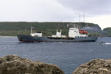 A port side view showing the Russian Federated Navy (RFN) Dubna Class Replenishment Oiler, PECHENGA, being escorted by a harbor patrol craft as it enter Apra Harbor, Guam (GU). The ship is one of four RFN Ships participating with two US Navy Ships in Passing Exercise 2006 (PASSEX 06) off the coast of Guam. PASSEX 06 is an exercise designed to increase interoperability between the two navies while enhancing the strong cooperative relationship between Russia and the United States