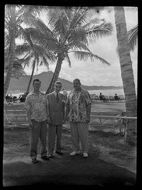 Three unidentified men, beach, Honolulu, Hawaii