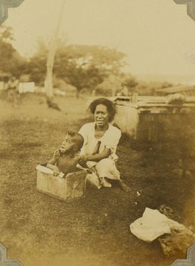 Tongan mother bathing a child in a kerosene tin, 1928