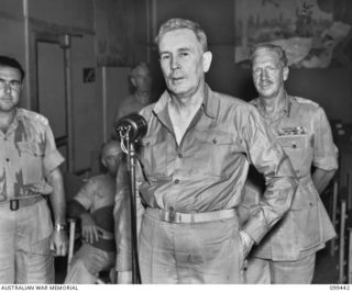 The Right Honourable J B Chifley, Prime Minister of Australia (standing at the microphone) addressing troops over the Australian Amenities Services broadcasting station 9AB. He paid a surprise ..