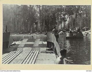 JACQUINOT BAY, NEW BRITAIN. 1945-04-17. MEMBERS OF 41 LANDING CRAFT COMPANY ON THE BARGE AB2027 AS THE VESSEL APPROACHES THE BEACH HEAD AFTER AN 80 MILE RUN FROM WIDE BAY