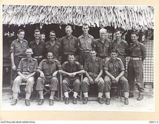 TOROKINA, BOUGAINVILLE. 1945-11-28. A GROUP OF OFFICERS AND SERGEANTS OF THE AMENITIES BRANCH, HQ 3 DIVISION. (FOR IDENTIFICATION OF 14 NAMED PERSONNEL REFER TO PROVISIONAL CAPTION OR NAME INDEX)