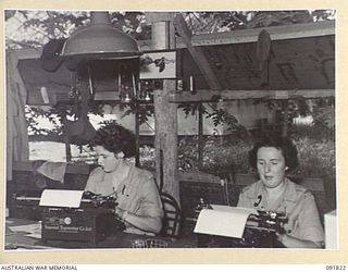 LAE, NEW GUINEA. 1945-05-15. PRIVATE S. WHITING (1), AND PRIVATE S. WILD (2), AT WORK WITH GENERAL OPERATIONS, HEADQUARTERS FIRST ARMY. A FEW DAYS AFTER THEIR ARRIVAL FROM AUSTRALIA, AUSTRALIAN ..