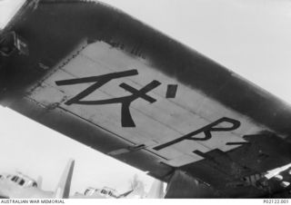 Wagga, NSW. c 1947. The inner section of the port (left hand) wing of a Beaufort bomber aircraft showing Japanese Kanji characters painted on the underside of the wing. The message was painted from ..