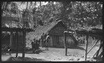 Man and boys near houses