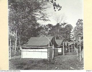 LAE, NEW GUINEA. 1944-07-01. AUSTRALIAN ARMY TENTS WHICH HAVE BEEN MODIFIED BY ADDING WALLS OF SISALCRAFT. THIS MODIFICATION ADDS TO THE WATERPROOFING AND INSULATING QUALITIES OF THE ISSUE TENTS