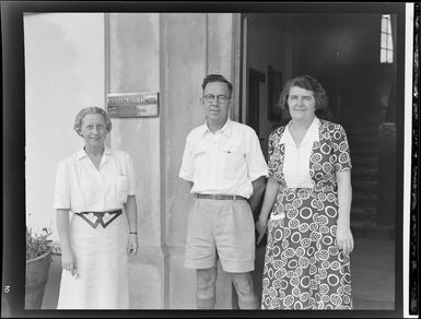 Unidentified man and two women outside the front doors of Northern Hotels, Fiji