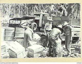 MILILAT, NEW GUINEA. 1944-08-02. TROOPS OF HEADQUARTERS, 5TH DIVISION UNLOADING THE UNIT BEER ISSUE FROM BARGES. IDENTIFIED PERSONNEL ARE:- TX6183 LIEUTENANT R.C. SADLER (2)