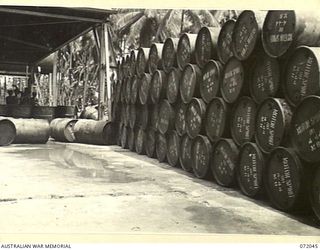 MILNE BAY, NEW GUINEA. 1944-04-04. 44 GALLON DRUMS TESTED, CLEANED AND STACKED AWAITING FILLING WITH 80 OCTANE MOTOR SPIRIT AT THE 2ND AUSTRALIAN BULK PETROLEUM STORAGE COMPANY