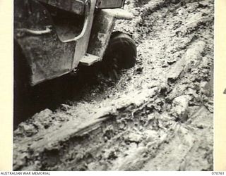 WAMPIT, NEW GUINEA. 1944-03-01. THE ROAD 65 1/2 MILES FROM WAU. AT THIS POINT THE WAU - LAE ROAD SECTION IS NOTHING MORE THAN MUD TRACKS. IT IS AN OPERATIONAL AREA OF THE HEADQUARTERS, COMMANDER ..