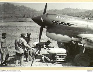 PAPUA, NEW GUINEA. 1942-07-27. "ABDUL THE BULL", A PLANE OF A ROYAL AUSTRALIAN AIR FORCE FIGHTER SQUADRON, TAKEN ON ITS BOMB LOAD, PRIOR TO SETTING OUT ON A RAID OVER JAPANESE OCCUPIED AREAS