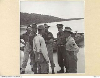 MUSCHU ISLAND, NEW GUINEA. 1945-09-10. COLONEL N.H. SAXBY, ASSISTANT DIRECTOR OF MEDICAL SERVICES 6 DIVISION AND T/SERGEANT E.J. OKAZAKI, US INTERPRETER, DISCUSSING ARRANGEMENTS FOR MEDICAL PARADE ..