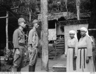 Bitagalip, New Britain. Two native FMI (Daughters of Mary Immaculate) sisters of the Ramale Mission identifying two Japanese soldiers who had tortured them