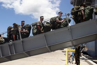 Numerous US Marine Corps (USMC), US Navy (USN) and Australian (AUS) Army units, board the USN Amphibious Assault Ship USS TARAWA (LHA 1) at pier K-10, Pearl Harbor, Hawaii (HI), in support of an amphibious exercise, Rim Of The Pacific (RIMPAC) 2004