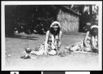 Hawaiian women sitting in grass